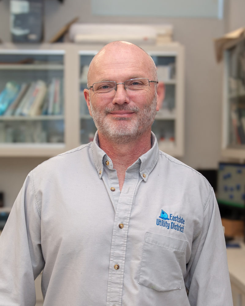 Portrait of Richard Davis in the Eastside Utility District laboratory.