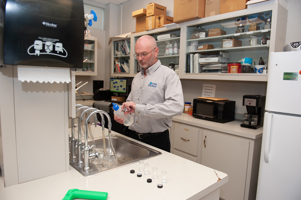 Richard Davis preparing water samples in a laboratory.