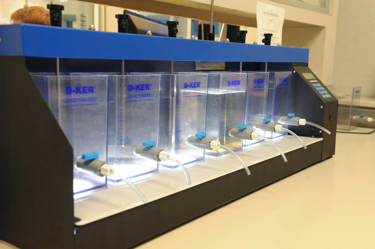 Laboratory testing equipment with multiple clear sample chambers used to test water